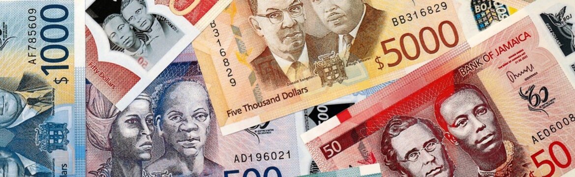 Jamaican dollar money bills in pile on table. Jamaica JMD currency cash close up