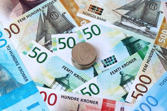 Norwegian krone money banknotes and coins on table. Norway cash bills of NOK currency