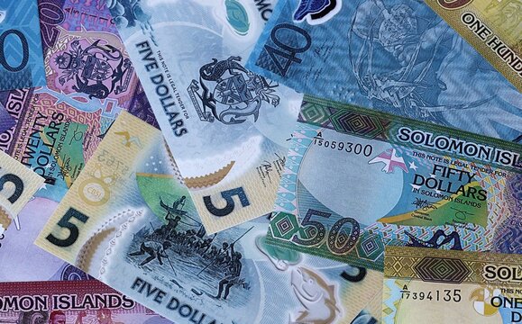 Solomon Islands dollar money bills in pile. Big amount of Solomon Islands SBD currency cash close up