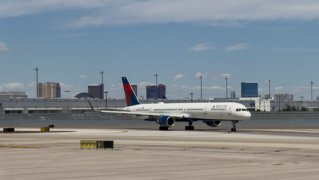 LAS VEGAS, NV, APR 28, 2026: Delta Air Lines jet taxiing on the tarmac with Las Vegas Strip hotels and casinos visible in the background