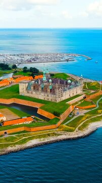 Vertical video. Helsingor, Denmark. A 16th-century castle with a banquet hall and royal chambers. The prototype of Elsinore Castle in the play Hamlet. Drone footage, Point of interest. Rich colors