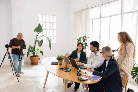 Corporate team collaborating during studio business photoshoot
