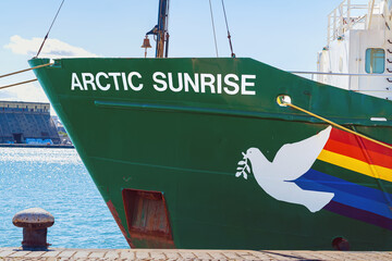 Obraz premium Burgas, Bulgaria - September 07, 2026: Bow of Greenpeace Arctic Sunrise with peace dove graphic. Bow of Greenpeace research vessel with ship name, white peace dove, multicolored hull graphic at port