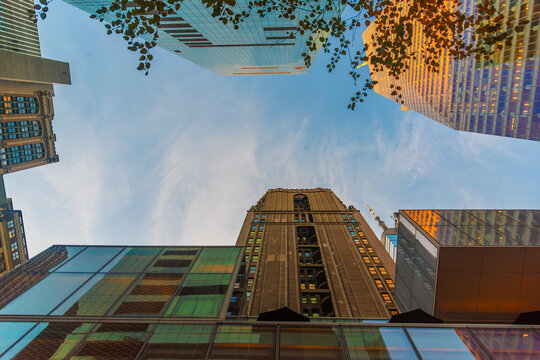 New York skyscrapers viewed from below at sunset