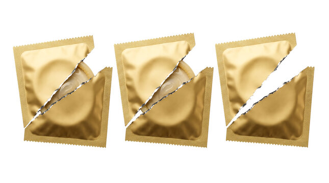 Torn golden condom foil packets with visible rolled latex contraceptives and opened packaging concept display isolated on a transparent background