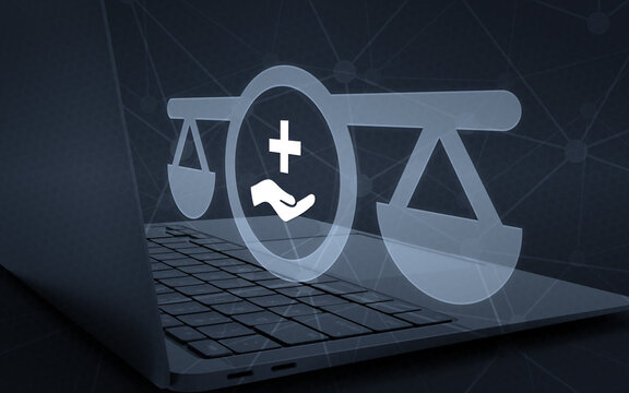 Medical law concept with scales of justice and healthcare symbol hovering over a modern laptop on dark digital background representing legal assistance and health regulation