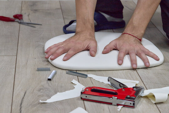 Indoor installation work: staple gun, fabric, wooden base, wooden floor 