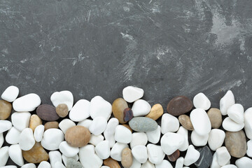 White pebble stones on concrete background, top view © Liami