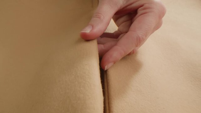 Light brown Beige wool coat background, natural sheepskin close-up macro coat. Top view