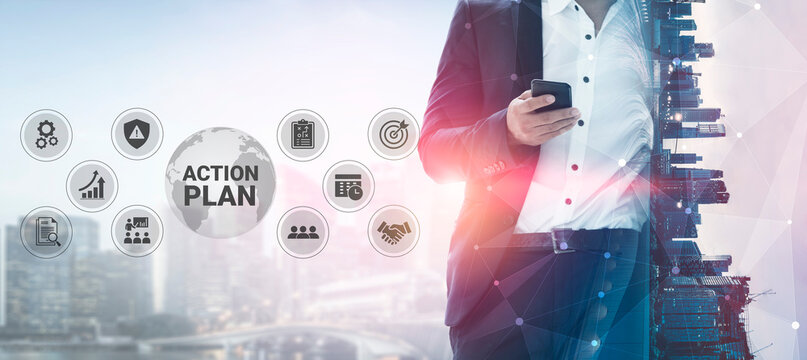 A businessman in a suit uses a smartphone to devise an action plan against a backdrop of cityscape, embodying strategy and innovation in a corporate setting. Ledger