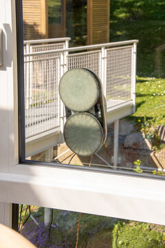 Window cleaning robot with dual pads attached to modern glass pane