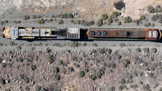 Aerial top down view of a freight train traveling through the Nevada desert