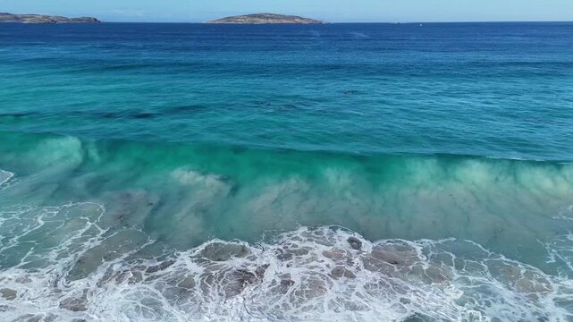 Aerial 4K drone video of ocean waves breaking on a rocky reef at West Beach, Western Australia