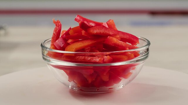 Red pepper ingredient, Fresh red hot chili peppers arranged around wooden bowl with sliced peppers 