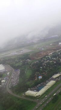 Aerial view of suburban neighborhood with greenery and overcast sky