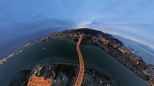 An tiny planet view Andaman Island with a prominent bridge over a river at dusk, showcasing urban lights