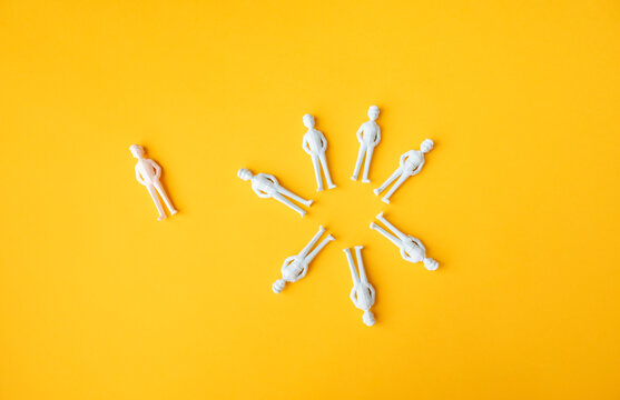 Workplace exclusion and outsider concept with one person left outside the team circle