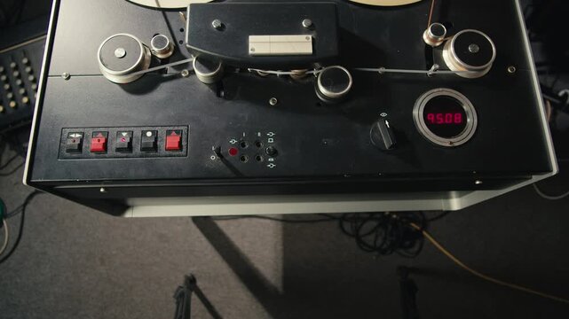Tape audio music player, studio magnetic tape, vintage retro spool reel to reel player and recorder, magnetic tape data storage close up, music studio. 