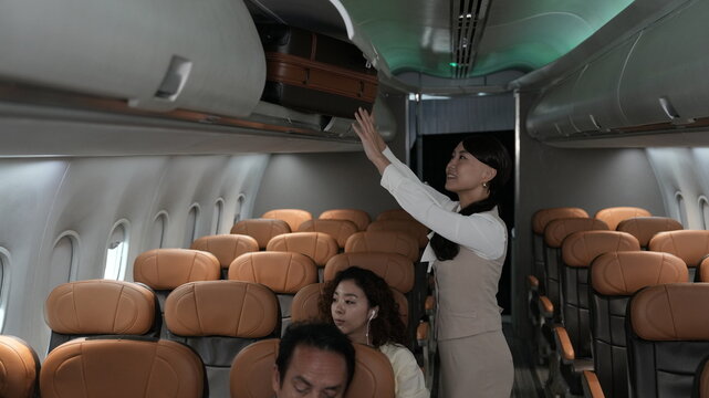 Flight attendants are serving passengers and providing in-flight safety instructions.