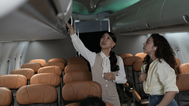 Flight attendants are serving passengers and providing in-flight safety instructions.