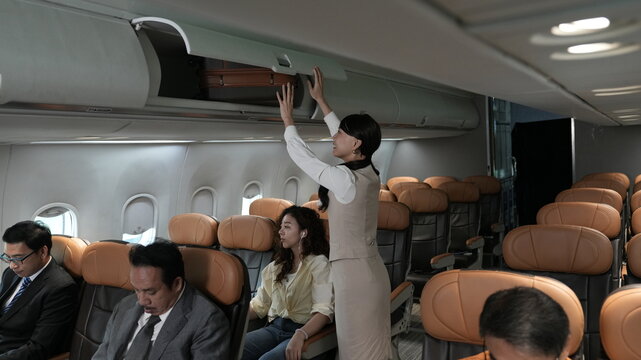 Flight attendants are serving passengers and providing in-flight safety instructions.