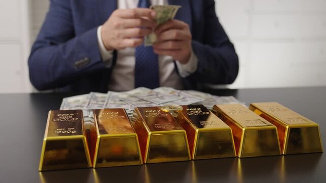 Rich businessman count gold bullion. Financial success. Successful rich man with gold. Business success man and gold bar. Investment in precious metal. Golden bullion. Golden bar