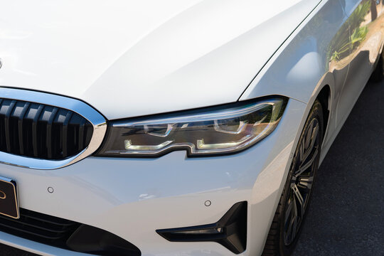 White BMW 320i Sedan Headlight Close-Up Detail
