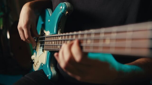 Bass guitar being played in a recording studio, rehearsal room, man playing jazz close up macro, vintage recording equipment
