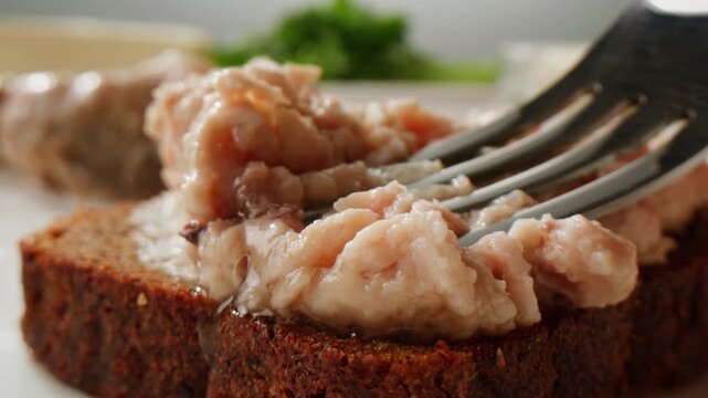Cod liver superfood can, omega 3 Smoked cod liver in oil in open tin can with fresh greens on wooden table. Seafoods delicacy