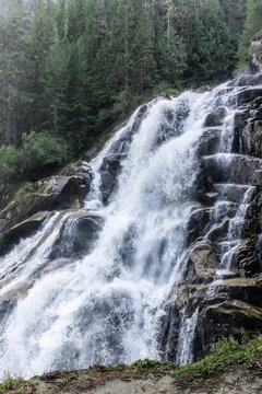 Waterfall cascading over rock ledges in a British Columbia forest