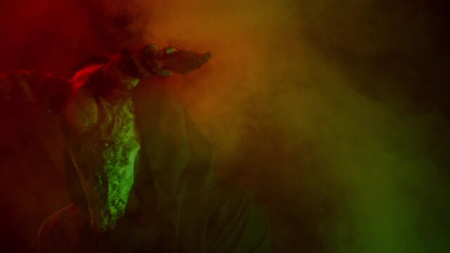 Demon with horns crawling in corridor. Silhouette of devil in darkness. Halloween, a traditional American holiday concept. Evil magician making rite or sacrifice during full moon, evil spirit, satan.