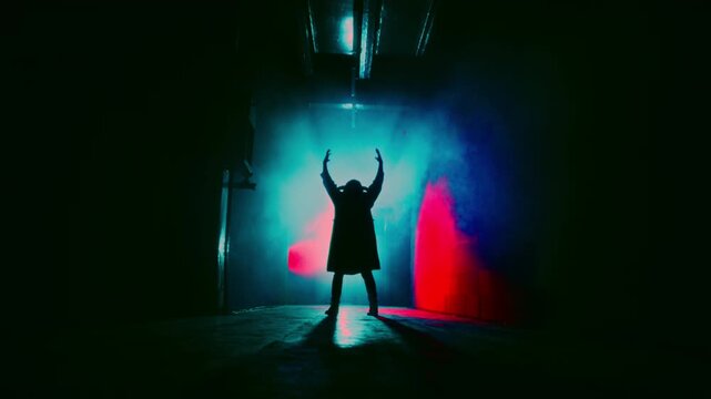 Demon with horns crawling in corridor. Silhouette of devil in darkness. Halloween, a traditional American holiday concept. Evil magician making rite or sacrifice during full moon, evil spirit, satan.