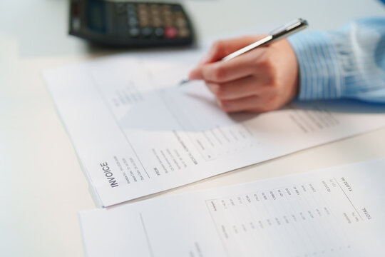 Close-up Accountant verifying financial billing statements and calculating expense totals, corporate bookkeeping, certified public accountant services, tax filing preparation, forensic audit diligence