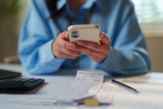 Corporate professional using a smartphone for two-factor authentication and mobile banking verification, secure financial transactions, cloud ERP workflows, digital treasury management