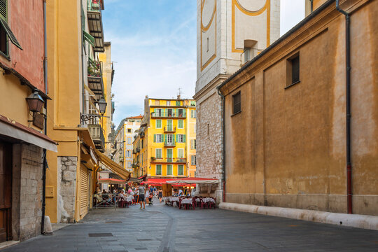 Tourists enjoy the shops and sidewalk cafes in the lively Place Rossetti, a vibrant square in the Vieux Nice Old town of Nice, France, along the Cote d'Azur French Riviera.