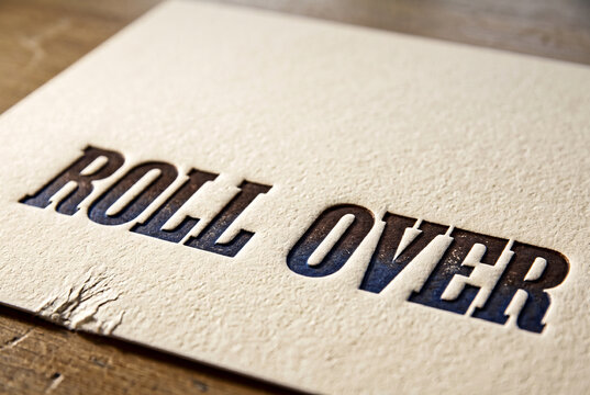 Rollover text on textured paper with dramatic embossed lettering
