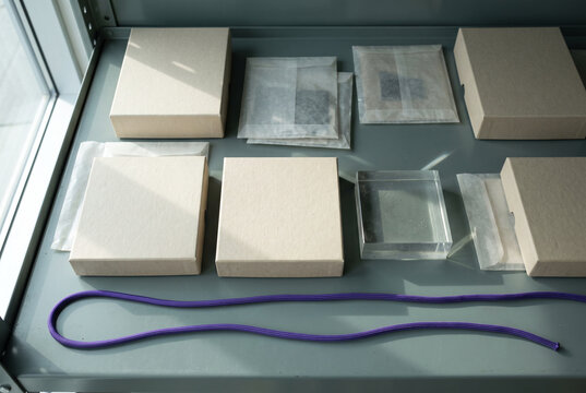 Beige packaging layout with rigid boxes acrylic block and purple cord