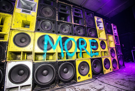 Sound system wall with stacked speakers and neon lighting