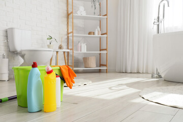 House cleaning and hygiene maintenance, plastic bottles with detergent and rubber gloves in a...