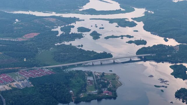 Aerial view shows winding river waterways cutting through islands. Bridge spans water at Tasik Raban
