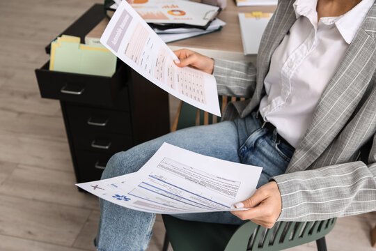 Businesswoman with documents working in office