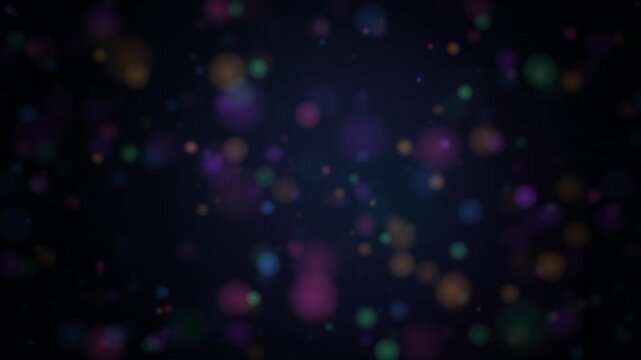 Colorful particles drift across a dark background in a looping motion sequence drifting