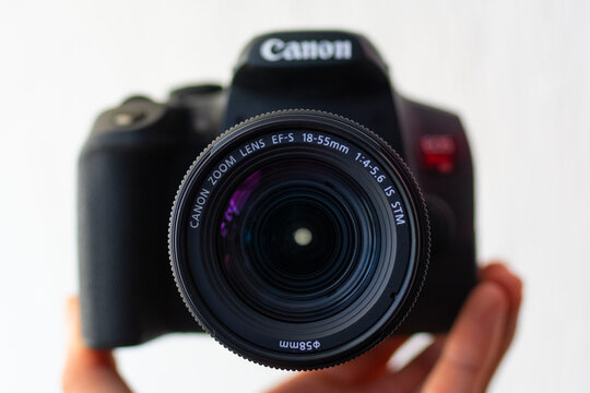 ZAPOPAN, MEXICO - SEPTEMBER 10, 2026: Hand holding Canon EOS Rebel T8i showing camera lens.