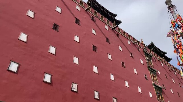 Potala Palace red exterior wall with traditional Tibetan architecture, prayer flags fluttering in wind, Lhasa Tibet