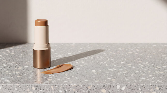 Foundation Makeup Stick with Bronze Base and Color Swatch on Terrazzo Surface