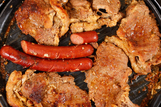 Brazilian barbecue with golden brown meats and grilled sausages, featuring a succulent texture and caramelized crust