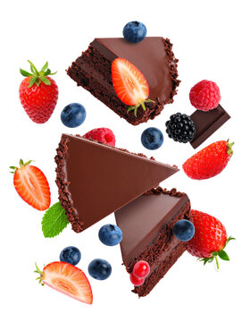 Three Slices of Chocolate Cake Floating with Fresh Berries and Chocolate Pieces