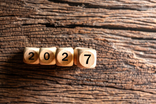 Wooden cubes displaying the year 2027 on a rustic wooden background