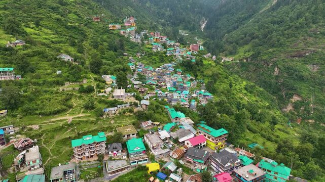 Drone view revealing the dramatic mountain topography and remote summer trekking infrastructure of Tosh in the Indian Himalayas.