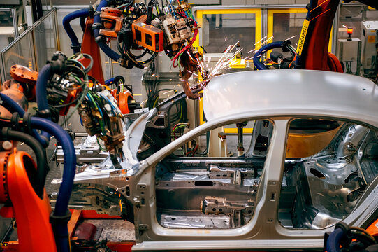 Automotive industry robotic arm assembly line